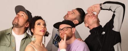 Five people looking upwards against a plain background.