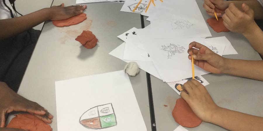 Children making clay tiles.