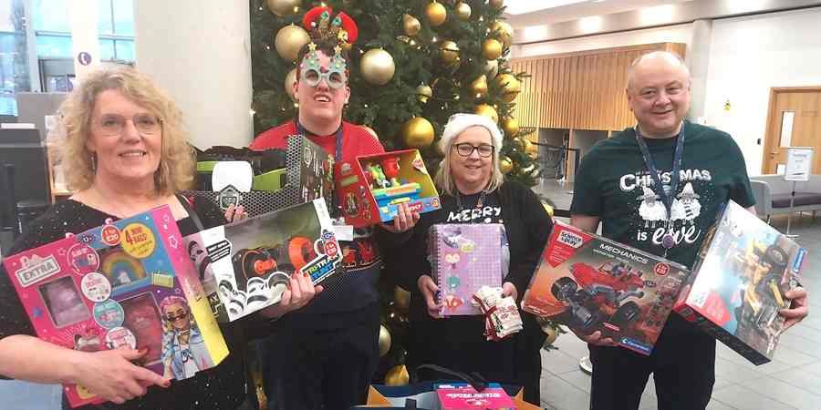 Helen Walton with colleagues, all holding donations given in the 2024 appeal.