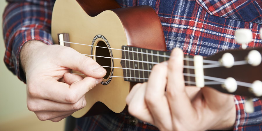 Person playing the ukulele.