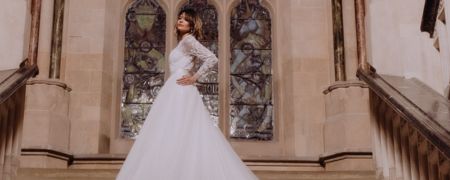 A person wearing a white wedding dress stood on an ornate staircase. (Image credit: khays_camera)