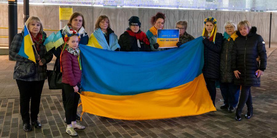 Rochdale residents holding the national flag of Ukraine.