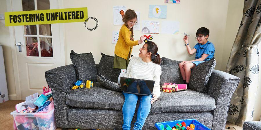 A foster carer and 2 children playing happily.