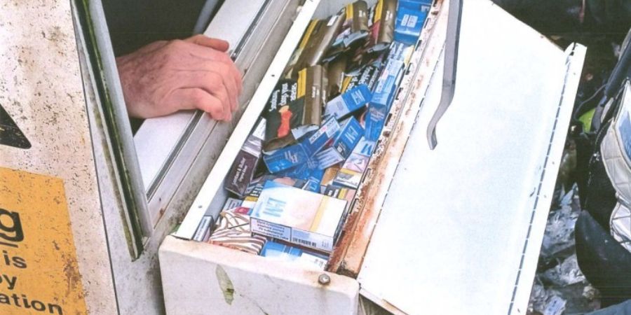 Packs of cigarettes in a white container.