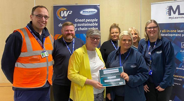 A business in the borough of Rochdale receiving a certificate from Councillor Janet Emsley