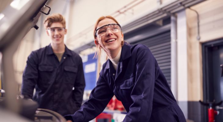 2 young people wearing overalls and goggles.