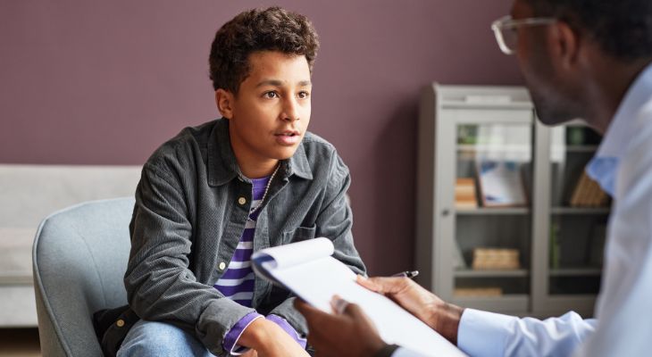 A young person speaking to a professional.