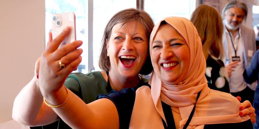 2 people taking a selfie and smiling.