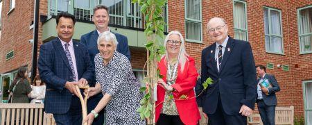 Councillors and board members of the Riverside Housing Group plant a tree, at the opening of the extra care scheme.