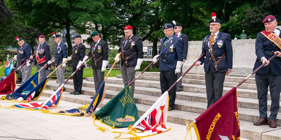 Veterans stood with lowered flags at the Cenotaph.