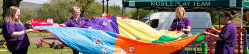 Council staff with a rainbow coloured parachute.