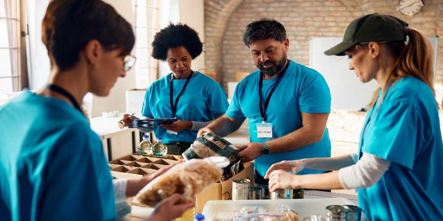 Volunteers at a food bank helping to put together food parcels.