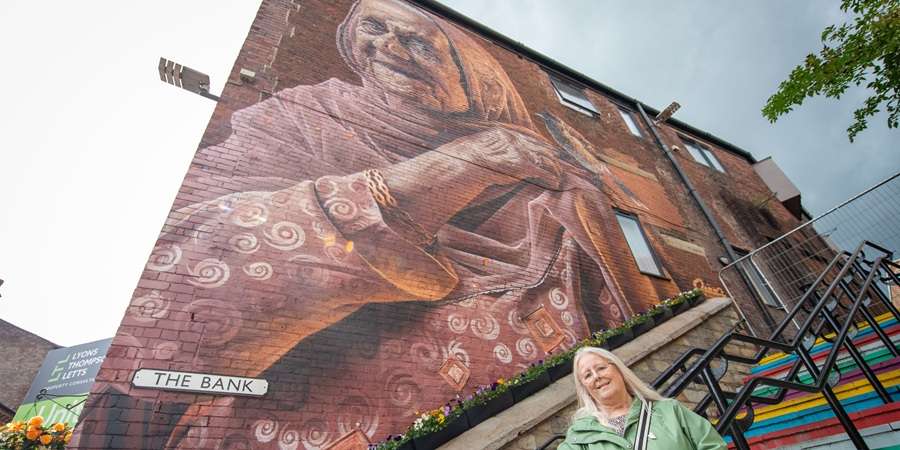 Councillor Sue Smith under a mural..