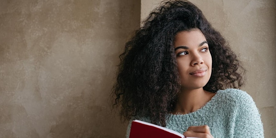 Woman holding a notepad.