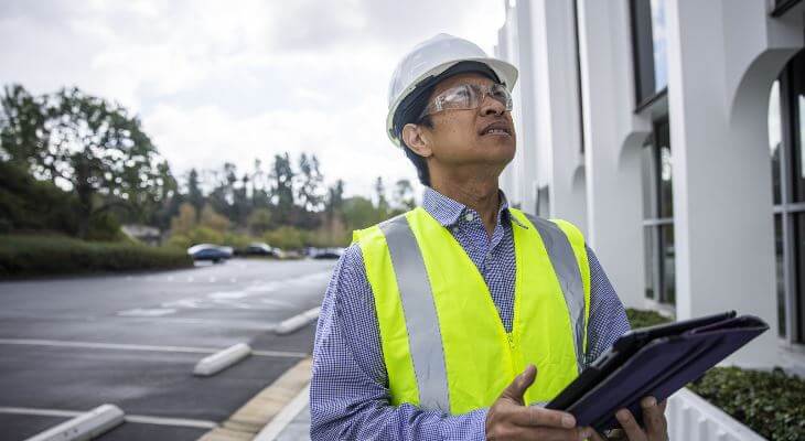 An engineer examining a building.