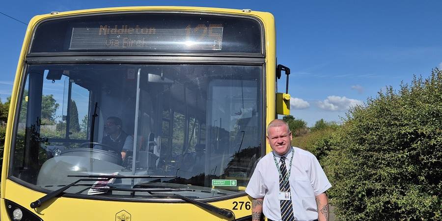 Councillor Phil Burke with a 125 bus.