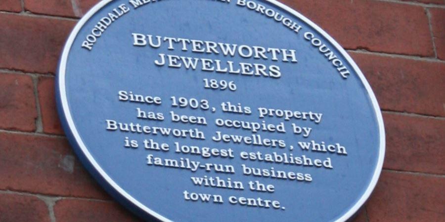 Blue plaque reading, Butterworth Jewellers, since 1903 this property has been occupied by Butterworth Jewellers, which is the longest established family run business within the town centre.