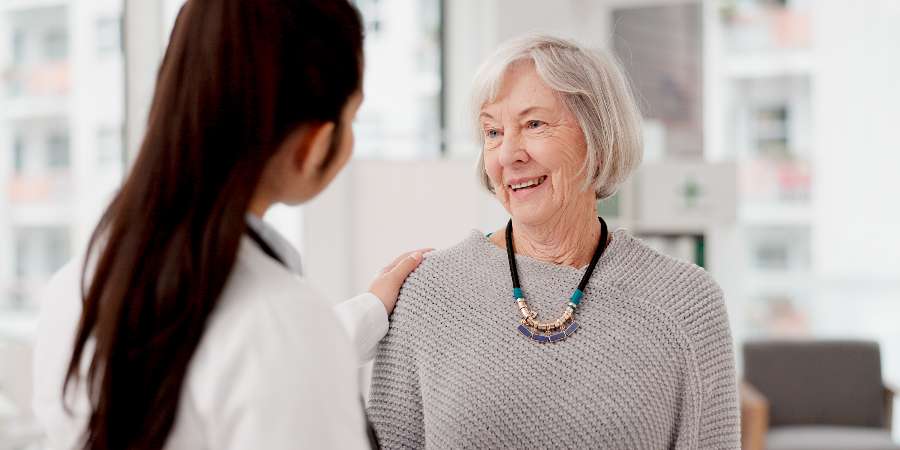 Adult carer with elderly person.