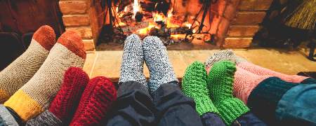 A family warming feet by the fireplace.