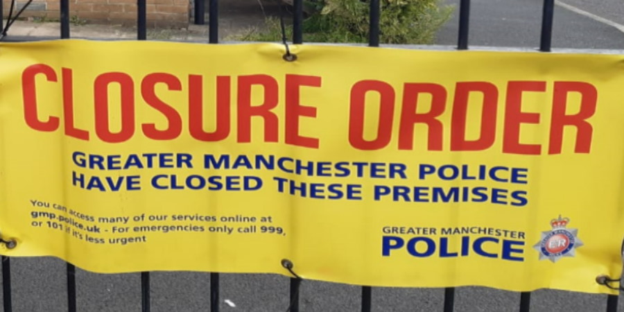 A yellow police closure order banner.