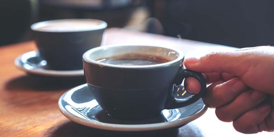 Hand holding a coffee cup.