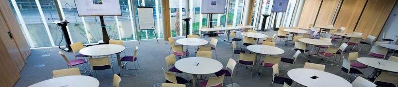 inside a meeting room with tables and chairs