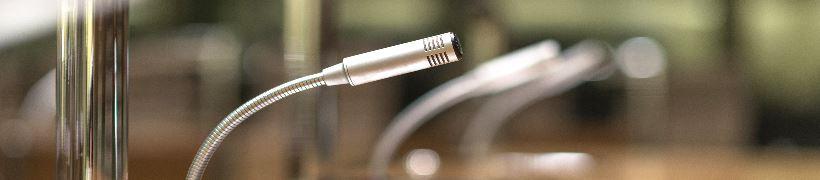 row of microphones on a bench