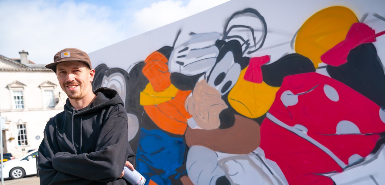 Artist with painting.
