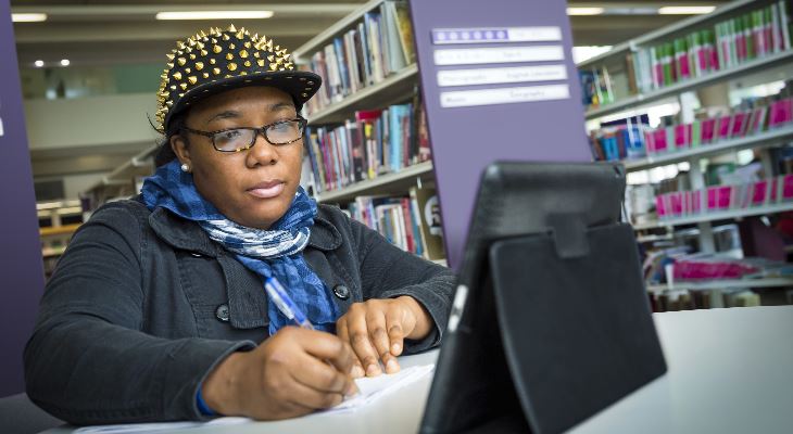 A woman using a computer in Rochdale Central Library.