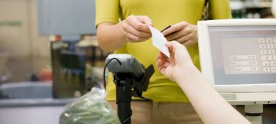 A cashier handing a receipt to a customer.