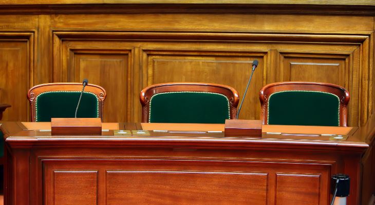 Empty chairs at a council table.