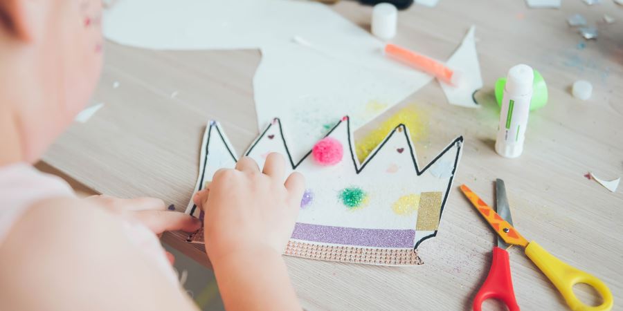 A child making a paper crown.