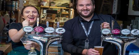 Bar staff at the Flying Horse Hotel pulling pints.