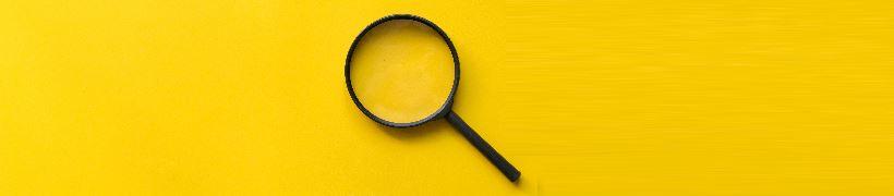 Magnifying glass on a plain background.