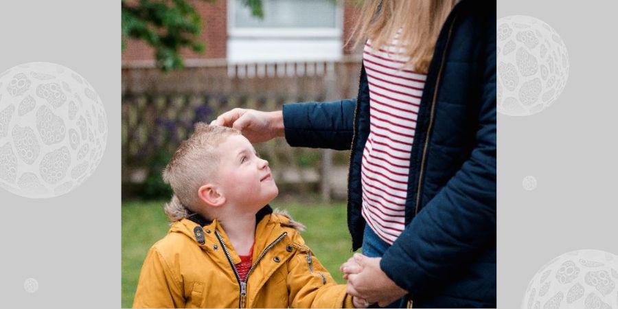 A little boy looking up to his mother.