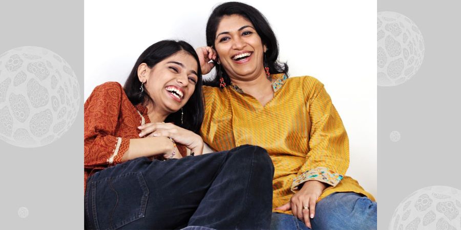 A girl and her mum laughing.