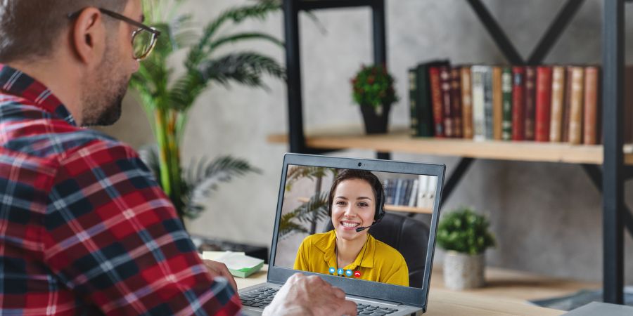 A man on a laptop Skype call with a woman.