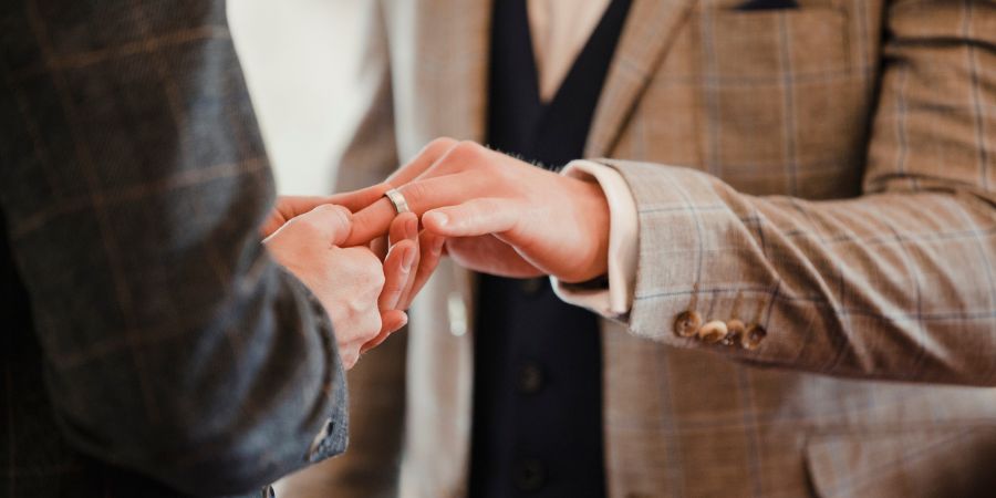 Men exchanging wedding rings.