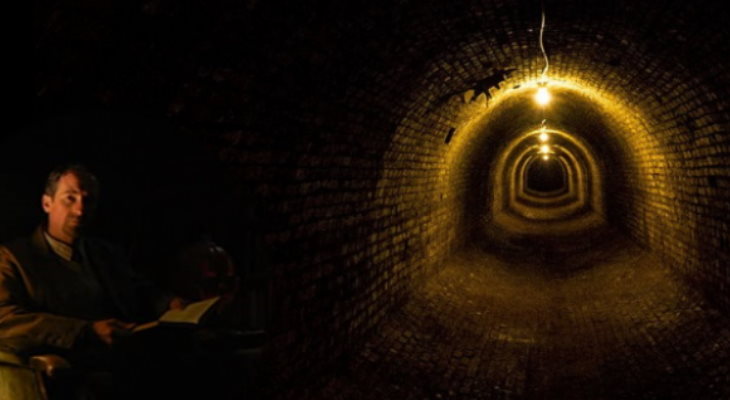 Storyteller in a dark tunnel.