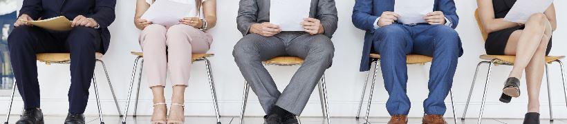 People holding their CVs, waiting to be interviewed.