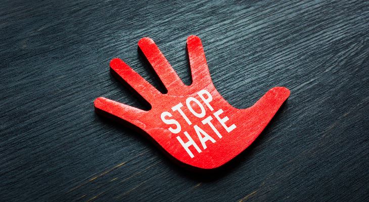 A red hand with the words Stop Hate.