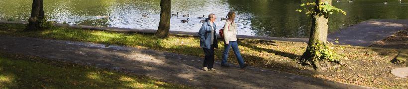 2 people walking in the woods.