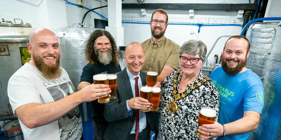 Councillor Janet Emsley and Paul Waugh MP with brewers.