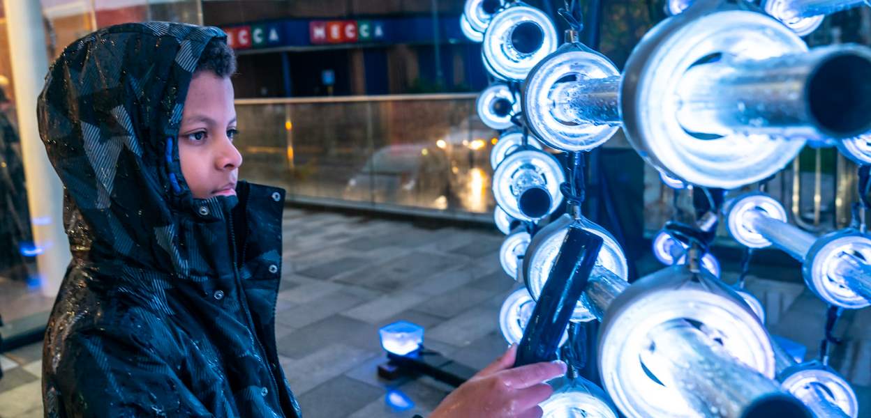 A visitor to the Rochdale switch-on using the Illumaphonium.