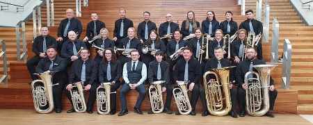 The Littleborough Band sitting with their instruments.