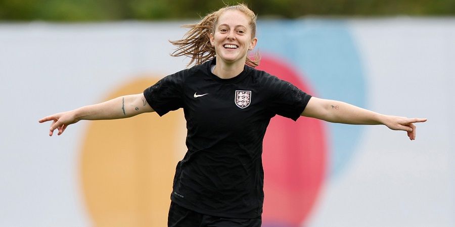 Keira Walsh with her arms outstretched in celebration.