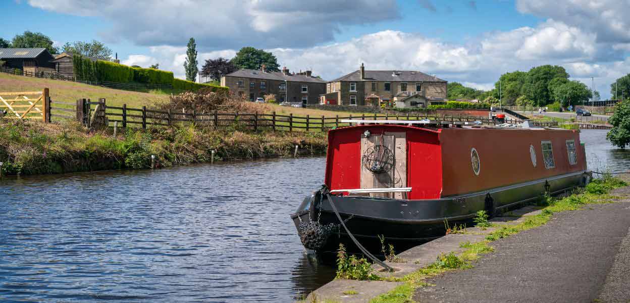 A canal boat on the Rochdale Canal at Littleborough.