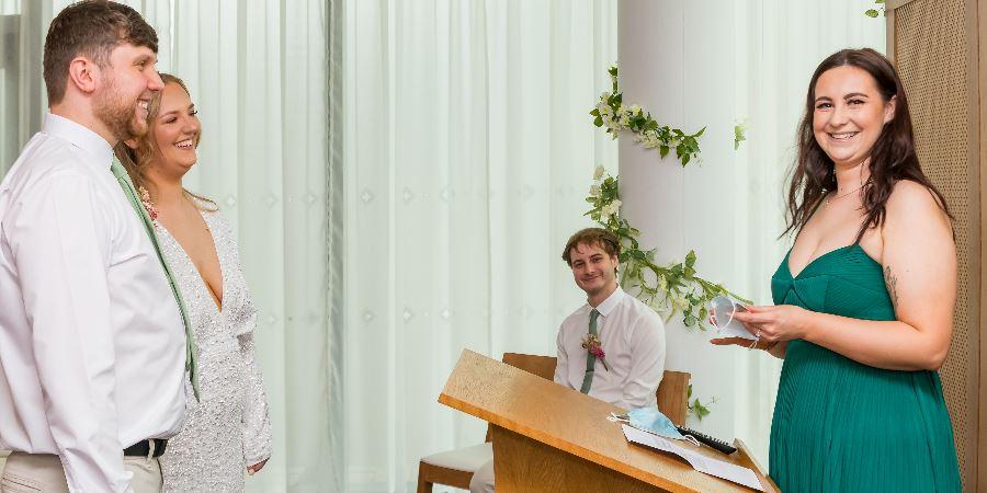 A couple getting married in the Red Rose Suite at Number One Riverside. 