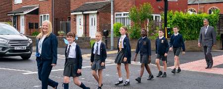 Headteacher Joanne Clinch using the new crossing with pupils and Councillor Shah Wazir.