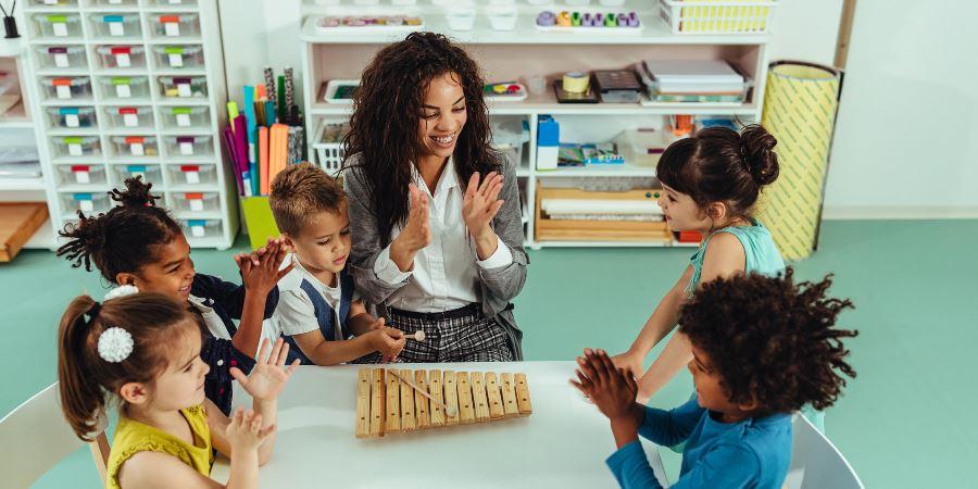 A centre worker leading a singing session with toddlers.